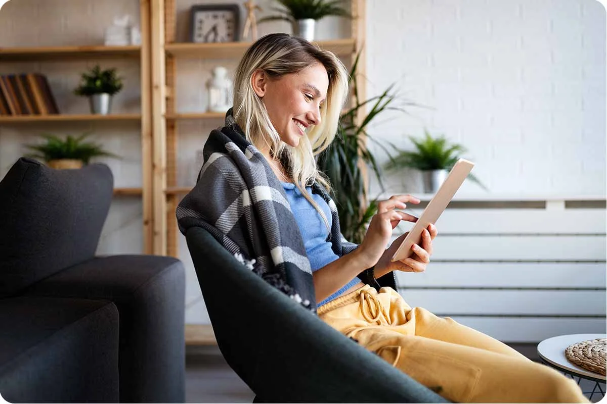 Woman enjoying Optimum Internet on her tablet