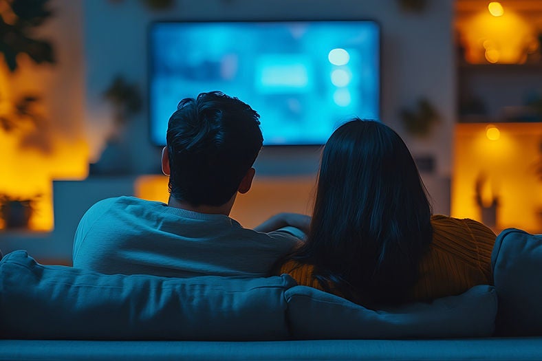 Couple watching TV using Optimum Extra TV